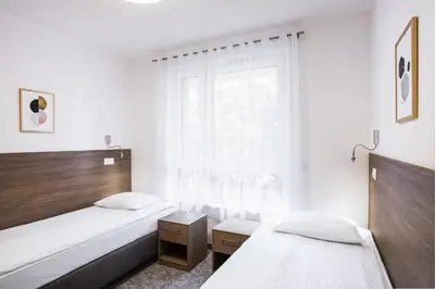 Łóżko lub łóżka w pokoju w obiekcie Bukowy Park Apartamenty