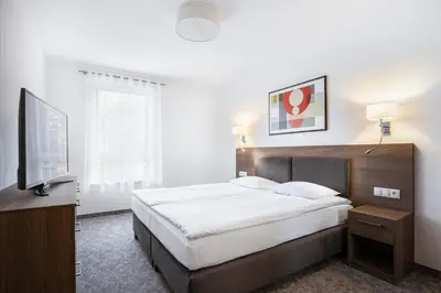 Łóżko lub łóżka w pokoju w obiekcie Bukowy Park Apartamenty