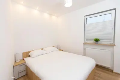 Łóżko lub łóżka w pokoju w obiekcie Apartamenty Grodowa 2
