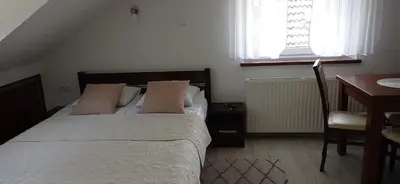 Łóżko lub łóżka w pokoju w obiekcie Wypoczynek Pod Lasem