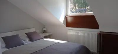 Łóżko lub łóżka w pokoju w obiekcie Wypoczynek Pod Lasem