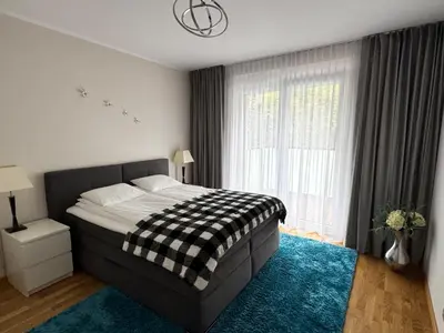 Łóżko lub łóżka w pokoju w obiekcie River Deluxe Atal Towers Apartment