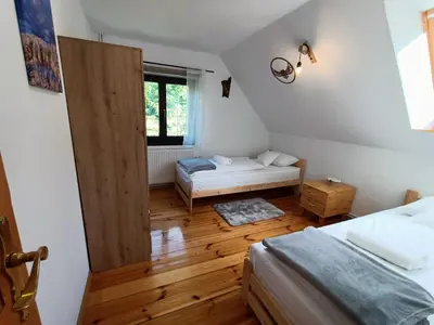 Łóżko lub łóżka w pokoju w obiekcie Dom nad Potokiem Sowa