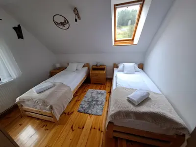 Łóżko lub łóżka w pokoju w obiekcie Dom nad Potokiem Sowa