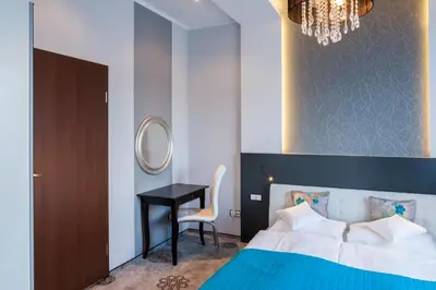 Łóżko lub łóżka w pokoju w obiekcie Hotel Mikulski
