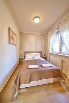 Łóżko lub łóżka w pokoju w obiekcie LAGUNA Apartament 9 Willa Ogrodowa