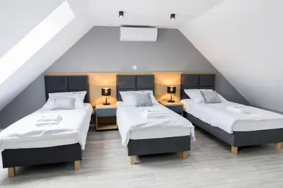 Łóżko lub łóżka w pokoju w obiekcie Koliberek Apartamenty