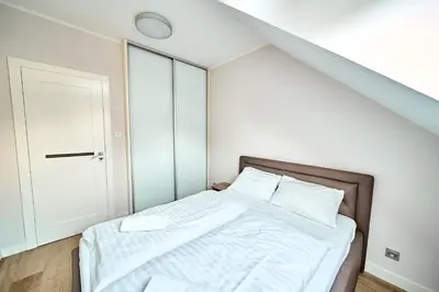Łóżko lub łóżka w pokoju w obiekcie Apartament 26A Willa Ogrodowa