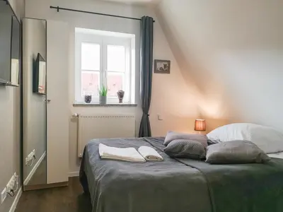 Łóżko lub łóżka w pokoju w obiekcie Zaułek Białoskórniczy