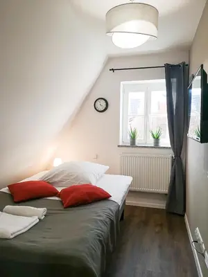 Łóżko lub łóżka w pokoju w obiekcie Zaułek Białoskórniczy