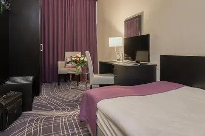 Łóżko lub łóżka w pokoju w obiekcie Sky Business Hotel