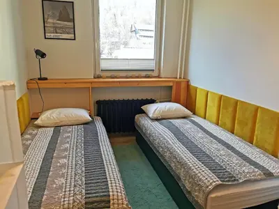 Łóżko lub łóżka w pokoju w obiekcie Apartament za Muzeum Papiernictwa