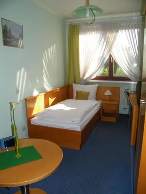Łóżko lub łóżka w pokoju w obiekcie Hotel Restauracja Tawerna Gliwice - duży parking gratis