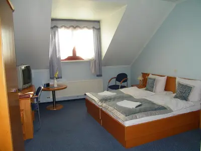 Łóżko lub łóżka w pokoju w obiekcie Hotel Restauracja Tawerna Gliwice - duży parking gratis