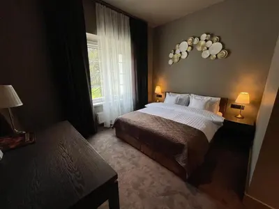 Łóżko lub łóżka w pokoju w obiekcie REZYDENCJA BOHEMA