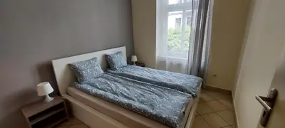 Łóżko lub łóżka w pokoju w obiekcie Apartament Zwycięstwa 45