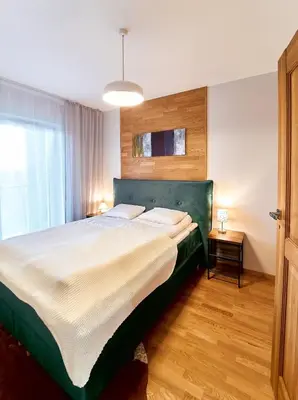 Łóżko lub łóżka w pokoju w obiekcie LAGUNA Apartament Polanica Residence 43 z garażem- SPA