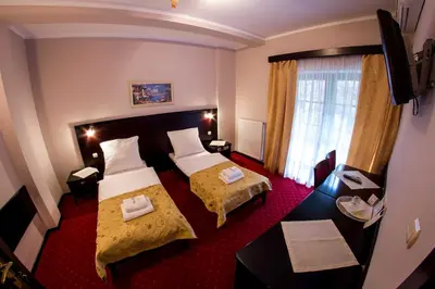 Łóżko lub łóżka w pokoju w obiekcie Hotel Maria