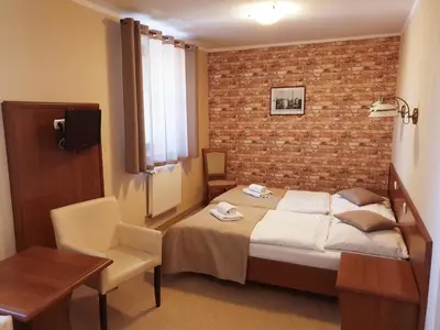 Łóżko lub łóżka w pokoju w obiekcie Hotel Zamkowy Młyn