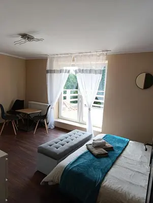 Łóżko lub łóżka w pokoju w obiekcie Sowi Gościniec Wellness & Breakfast