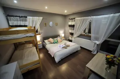 Łóżko lub łóżka w pokoju w obiekcie Sowi Gościniec Wellness & Breakfast