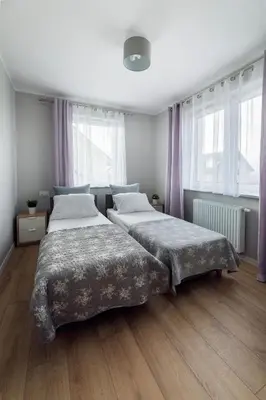 Łóżko lub łóżka w pokoju w obiekcie Apartament Liliowa 4 z tarasem