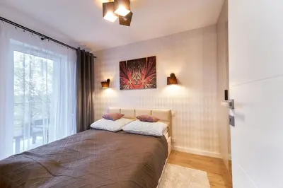 Łóżko lub łóżka w pokoju w obiekcie LAGUNA Apartament Polanica Residence 45