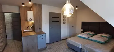 Łóżko lub łóżka w pokoju w obiekcie Apartamenty Majówka