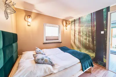 Łóżko lub łóżka w pokoju w obiekcie Marel-Apartments Domek Duna Lux Polanica Zdrój