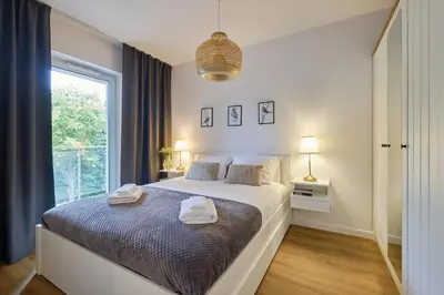 Łóżko lub łóżka w pokoju w obiekcie Apartament Green Park, Polanica Residence, garaż podziemny & mini SPA & Rowery