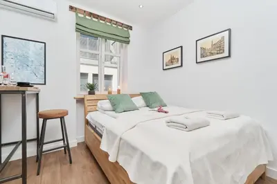 Łóżko lub łóżka w pokoju w obiekcie City Center Studio Wrocław by Noclegi Renters