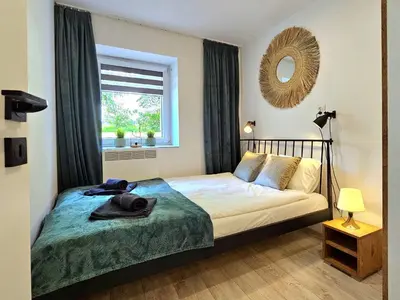 Łóżko lub łóżka w pokoju w obiekcie Apartament Słoneczne Okno