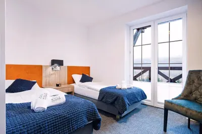 Łóżko lub łóżka w pokoju w obiekcie Willa Pod Janowcem SPORT - REST & SPA