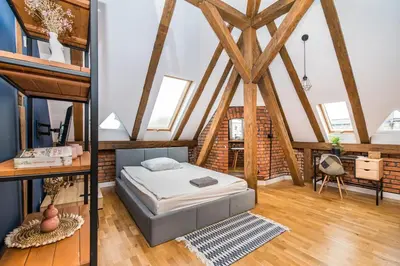 Łóżko lub łóżka w pokoju w obiekcie Przytulny Apartament Z Wieżą