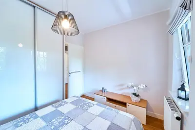 Łóżko lub łóżka w pokoju w obiekcie Apartament 26 Willa Ogrodowa