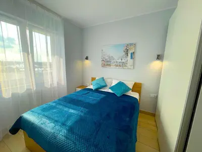Łóżko lub łóżka w pokoju w obiekcie Apartament z tarasem i widokiem na Odrę