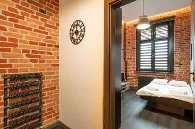 Łóżko lub łóżka w pokoju w obiekcie Piłsudskiego48
