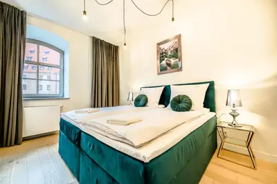 Łóżko lub łóżka w pokoju w obiekcie AboutArtApartments - Młyn Maria