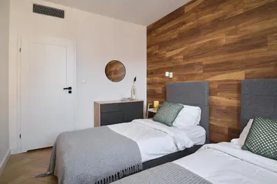 Łóżko lub łóżka w pokoju w obiekcie LeoApart Solny Square ApartHotel
