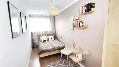 Łóżko lub łóżka w pokoju w obiekcie UniApart