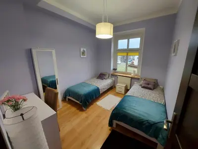 Łóżko lub łóżka w pokoju w obiekcie Apartament Mariacka