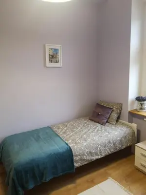 Łóżko lub łóżka w pokoju w obiekcie Apartament Mariacka
