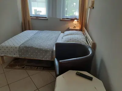 Łóżko lub łóżka w pokoju w obiekcie Pension Etiuda