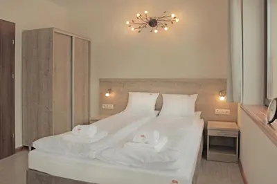 Łóżko lub łóżka w pokoju w obiekcie Bursztynowe Buki