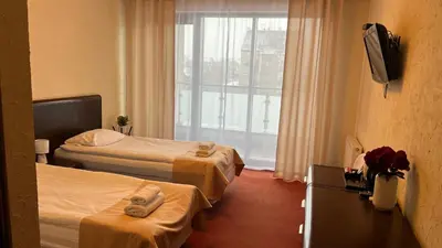 Łóżko lub łóżka w pokoju w obiekcie Neptun