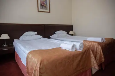 Łóżko lub łóżka w pokoju w obiekcie Neptun