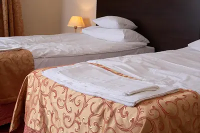 Łóżko lub łóżka w pokoju w obiekcie Neptun