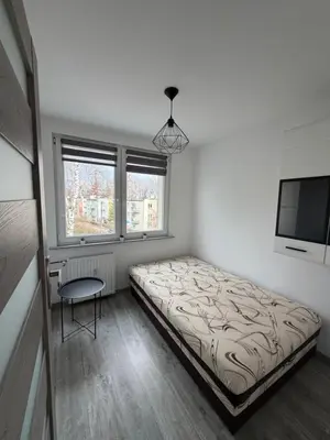 Łóżko lub łóżka w pokoju w obiekcie Apartament Zdrojowy