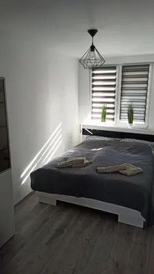 Łóżko lub łóżka w pokoju w obiekcie Apartament Zdrojowy