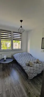 Łóżko lub łóżka w pokoju w obiekcie Apartament Zdrojowy